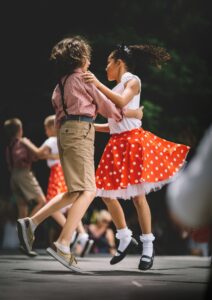 Children dancing, red polka dot skirt